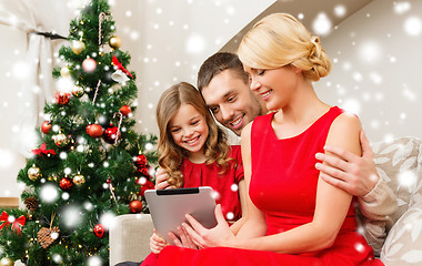 Image showing smiling family with tablet pc at home