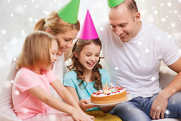 Image showing happy family with two kids in party hats at home