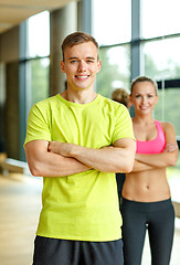 Image showing smiling man and woman in gym