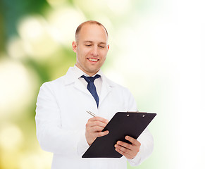 Image showing smiling male doctor with clipboard