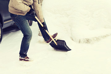 Image showing closeup of man shoveling snow from driveway