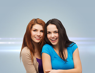 Image showing smiling teenage girls hugging