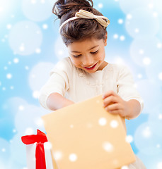 Image showing smiling little girl with gift box