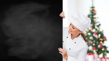 Image showing smiling female chef with white blank board