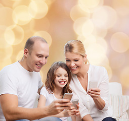 Image showing happy family with smartphones