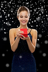 Image showing smiling woman holding red gift box