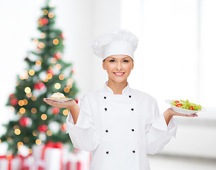 Image showing smiling chef with cupcake and salad on plates