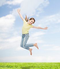 Image showing smiling little girl jumping