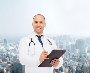 Image showing smiling male doctor with clipboard and stethoscope