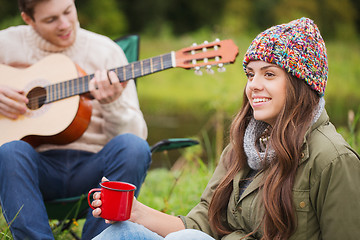 Image showing smiling couple with guitar in camping