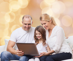 Image showing smiling family with laptop