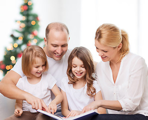 Image showing happy family with book at home