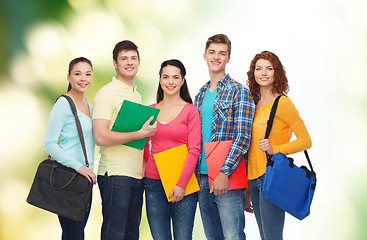 Image showing group of smiling teenagers over green background