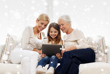 Image showing smiling family with tablet pc at home