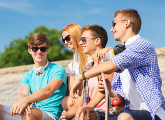 Image showing group of smiling friends sitting on city street