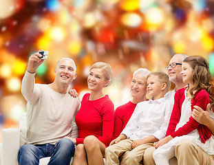 Image showing smiling family with camera