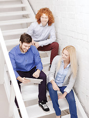 Image showing team with tablet pc computer sitting on staircase