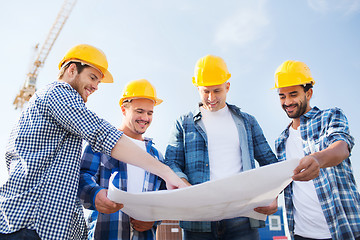 Image showing group of builders with tablet pc and blueprint