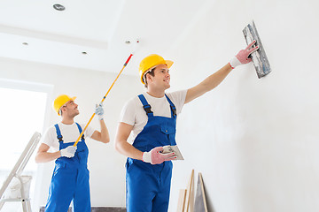 Image showing group of builders with tools indoors