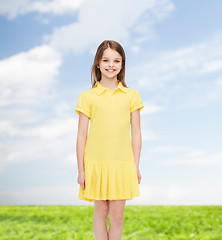 Image showing smiling little girl in yellow dress