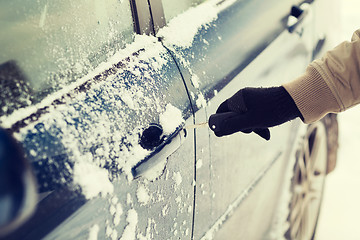 Image showing closeup of man hand opening car with key