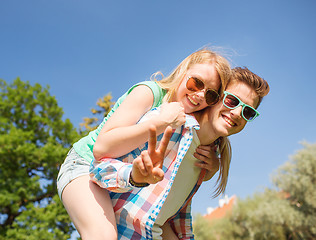 Image showing smiling couple having fun and showing victory sign