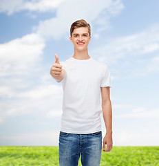 Image showing smiling man in white t-shirt showing thumbs up