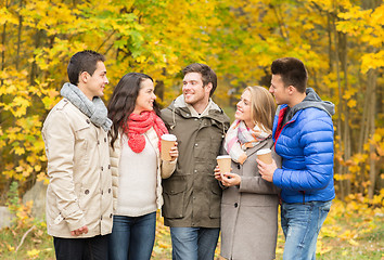 Image showing group of smiling friend with coffee cups in park