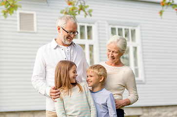 Image showing happy family in front of house outdoors