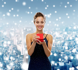 Image showing smiling woman holding red gift box