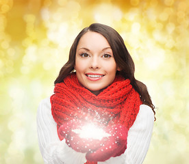 Image showing smiling woman in winter clothes with snowflake