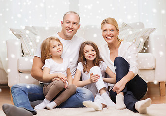 Image showing smiling parents and two little girls at home