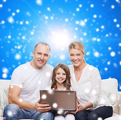 Image showing smiling family with laptop