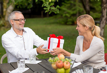 Image showing happy family having holiday dinner outdoors