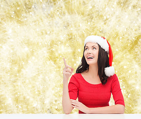 Image showing smiling woman in santa helper hat