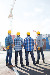 Image showing group of builders in hardhats outdoors