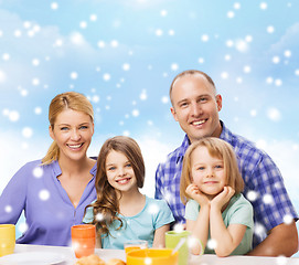 Image showing happy family with two kids having breakfast