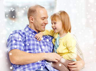 Image showing smiling father and daughter hugging at home