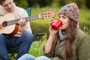 Image showing smiling couple with guitar in camping