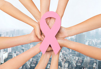 Image showing close up of hands with cancer awareness symbol