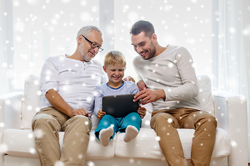 Image showing smiling family with tablet pc at home