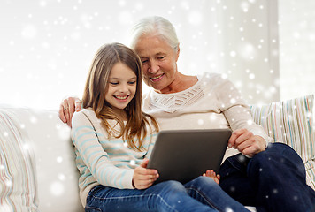 Image showing smiling family with tablet pc at home