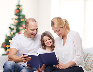 Image showing happy family with book at home