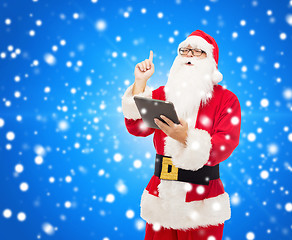 Image showing man in costume of santa claus with tablet pc