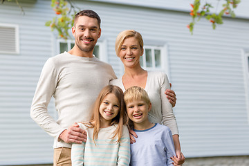 Image showing happy family in front of house outdoors