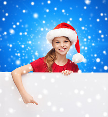 Image showing girl in santa helper hat with blank white board