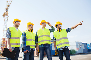 Image showing group of smiling builders with tablet pc outdoors