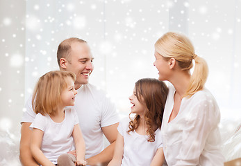 Image showing smiling parents and two little girls at home