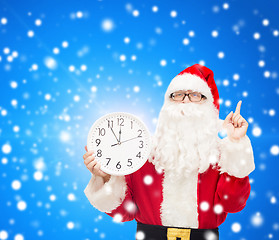 Image showing man in costume of santa claus with clock