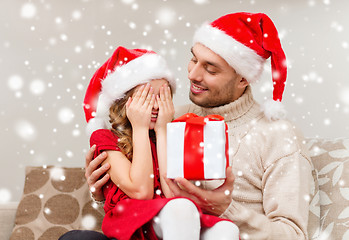 Image showing smiling father and daughter holding gift box